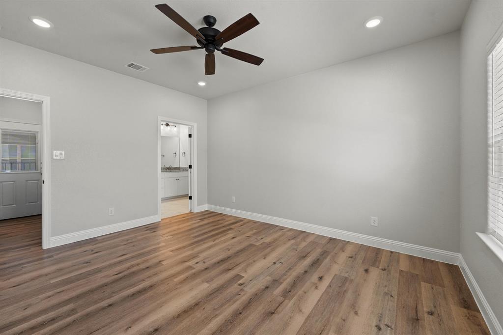 1568 Reverie Road Burleson, TX 76028 - Photo 17 of 26 an empty room with wooden floor and windows