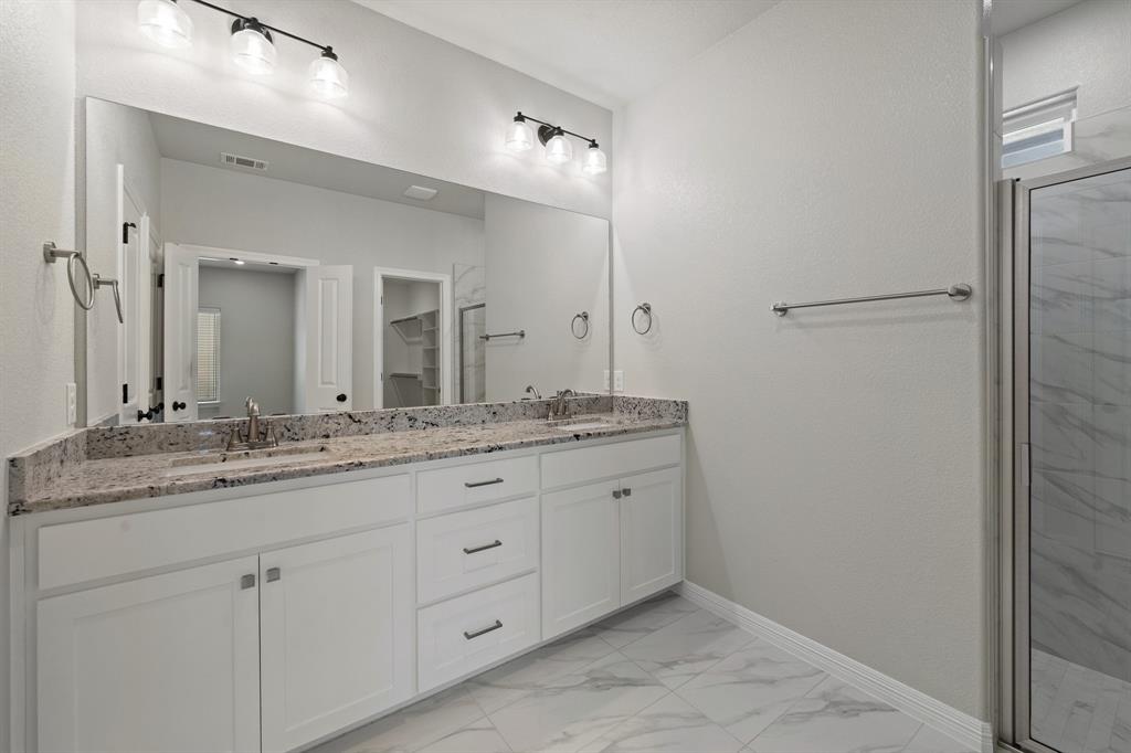 1568 Reverie Road Burleson, TX 76028 - Photo 18 of 26 a bathroom with a granite countertop sink two mirror and a