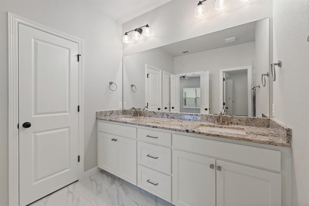 1568 Reverie Road Burleson, TX 76028 - Photo 19 of 26 a bathroom with double sink and a mirror