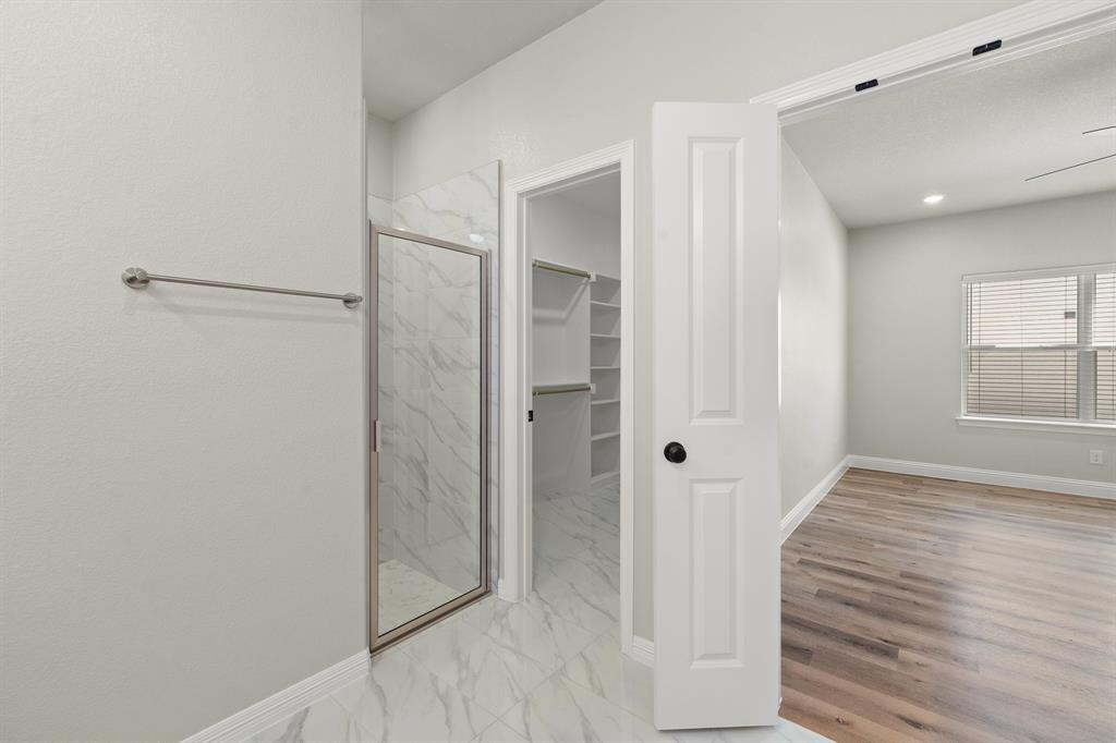 1568 Reverie Road Burleson, TX 76028 - Photo 20 of 26 a bathroom with a shower and a glass door