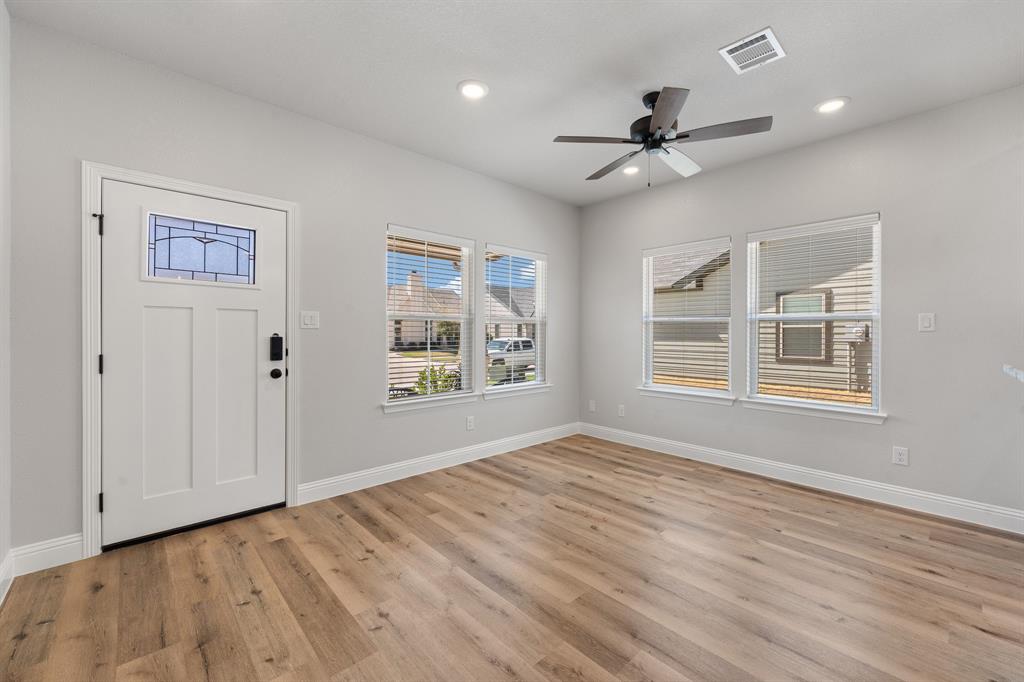 1568 Reverie Road Burleson, TX 76028 - Photo 4 of 26 a view of empty room with wooden floor and fan