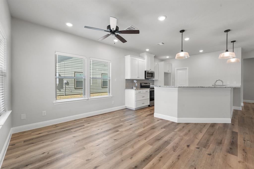 1568 Reverie Road Burleson, TX 76028 - Photo 5 of 26 a view of kitchen with cabinets and wooden floor