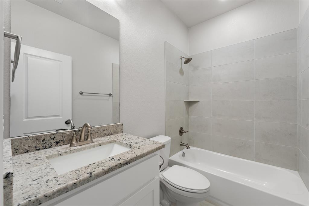 1568 Reverie Road Burleson, TX 76028 - Photo 9 of 26 a bathroom with a granite countertop sink toilet and shower