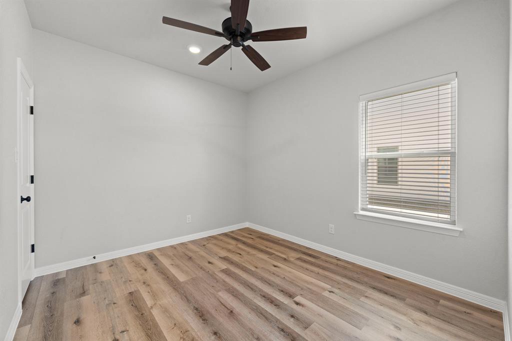 1568 Reverie Road Burleson, TX 76028 - Photo 10 of 26 a view of a room with a ceiling fan and wooden floor