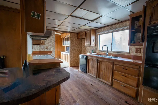 a kitchen with a sink stove and cabinets