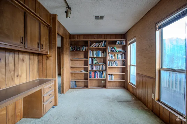 a view of an empty room with closet and wooden floor