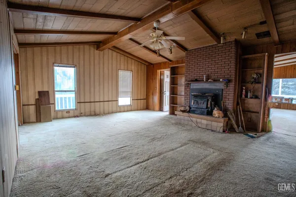 a view of empty room with a fireplace