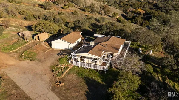 an aerial view of a house with outdoor space and a lake view