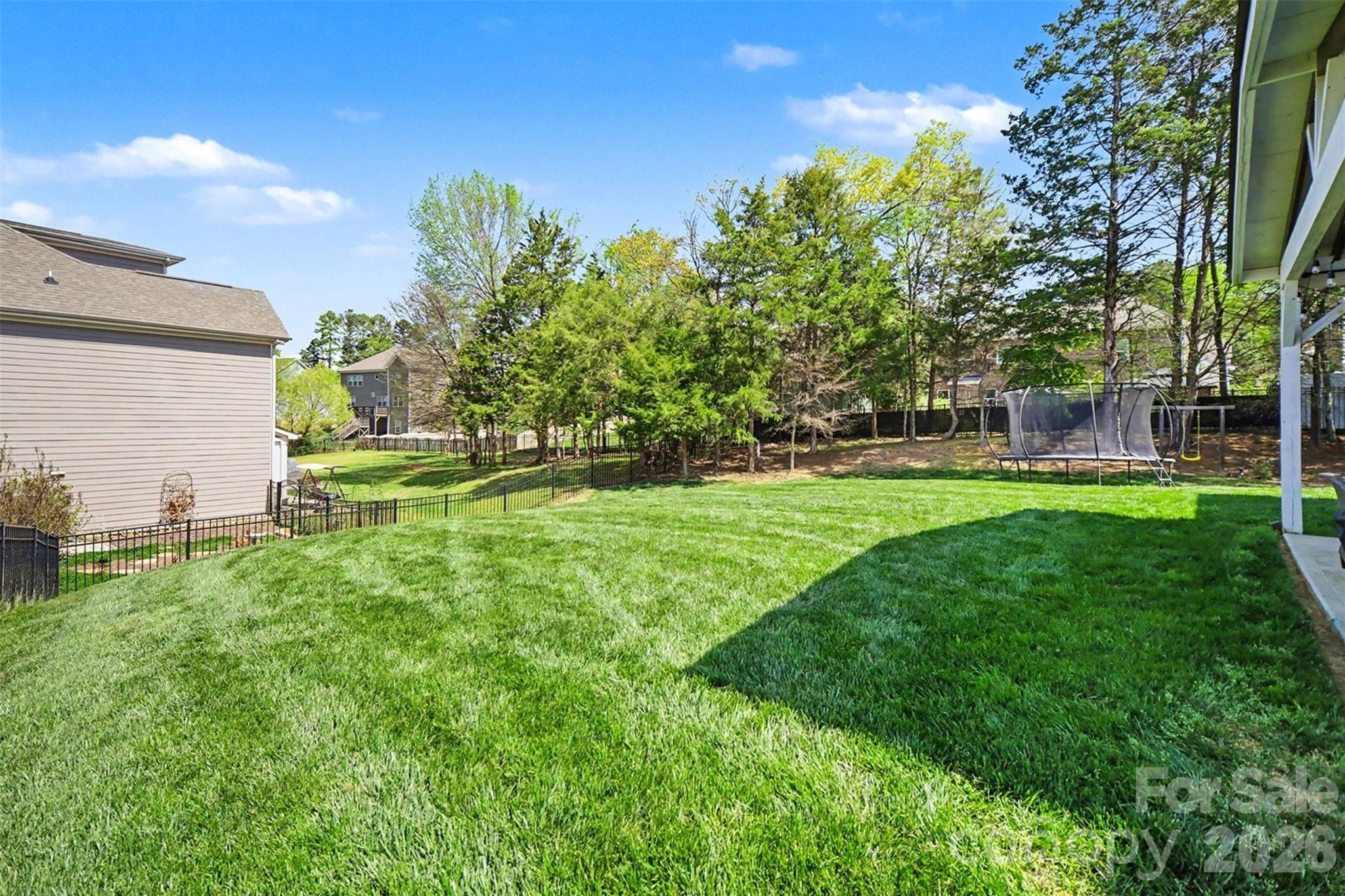 514 Tack Lane Midland, NC 28107 - Photo 41 of 48 a backyard of a house with lots of green space and fountain