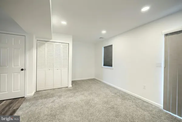 a view of empty room with wooden floor and stove