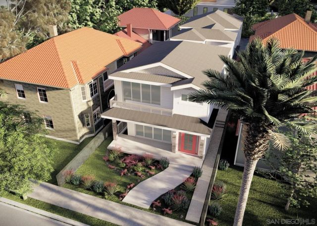 an aerial view of a house with garden space and street view