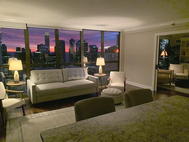 a kitchen with a chandelier a dining table and chairs