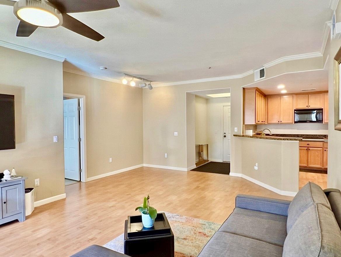 1310 Saddle Rack Street, Unit 347 San Jose, CA 95126 - Photo 5 of 42 a view of an empty room and kitchen with wooden floor