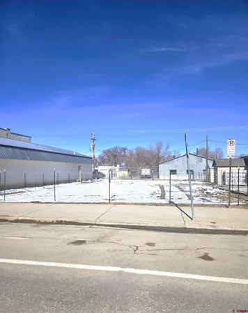 a view of dirt yard with a large tree
