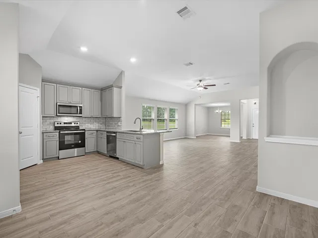 a view of kitchen with wooden floor and electronic appliances