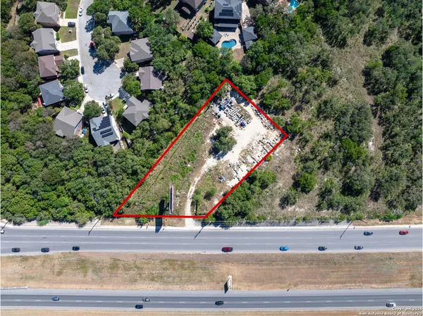 an aerial view of a house with a yard and outdoor seating