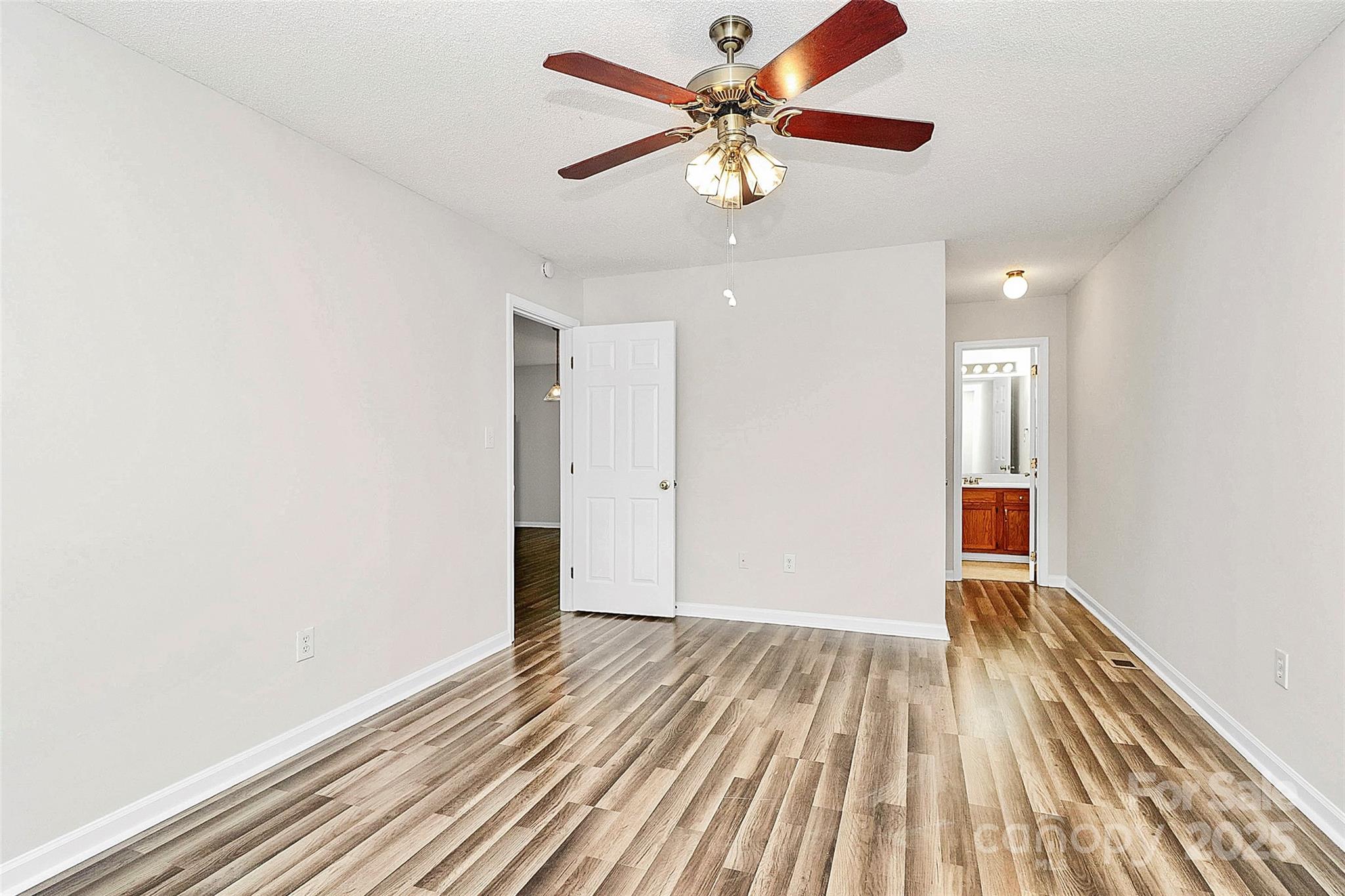5114 Daffodil Lane Concord, NC 28025 - Photo 12 of 30 wooden floor in an empty room with a window