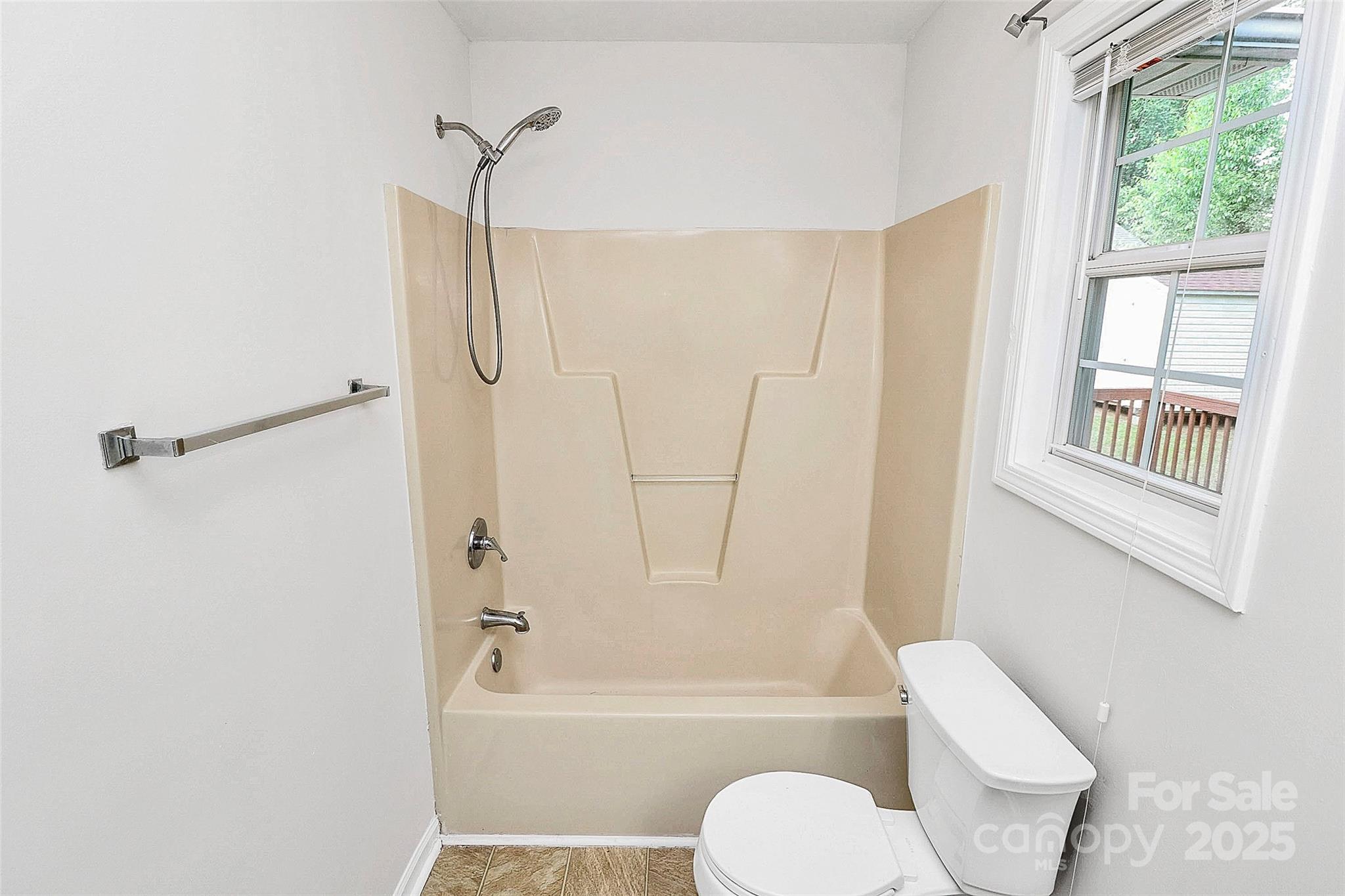 5114 Daffodil Lane Concord, NC 28025 - Photo 15 of 30 a bathroom with a toilet and a bath tub