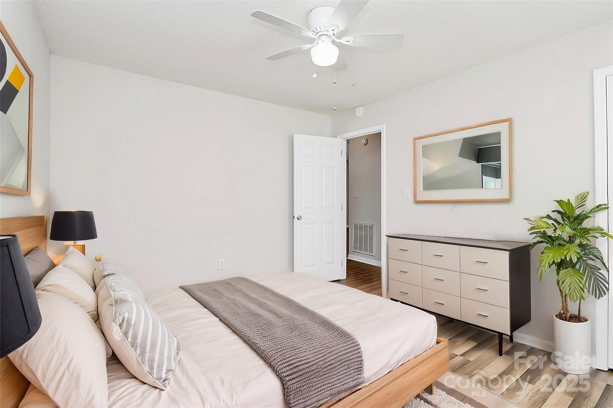 5114 Daffodil Lane Concord, NC 28025 - Photo 16 of 30 a bedroom with a bed and a potted plant