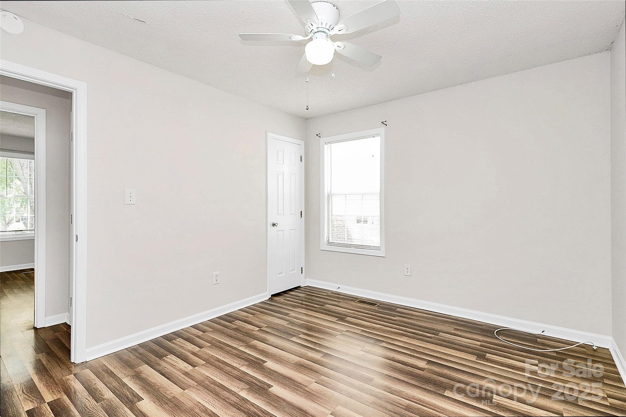 5114 Daffodil Lane Concord, NC 28025 - Photo 18 of 30 wooden floor in an empty room with a window