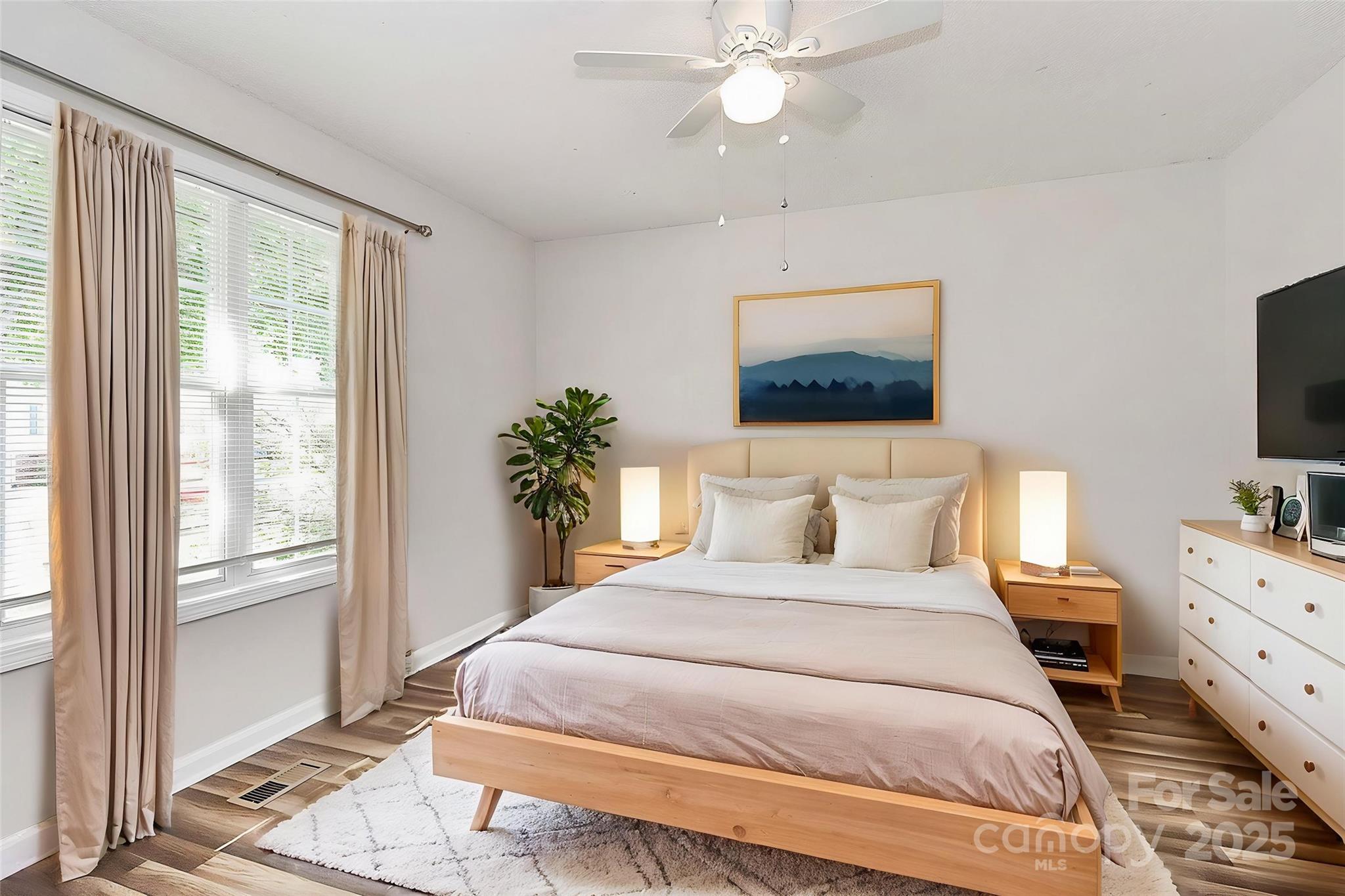 5114 Daffodil Lane Concord, NC 28025 - Photo 20 of 30 a bedroom with a large bed and a flat tv screen on dresser