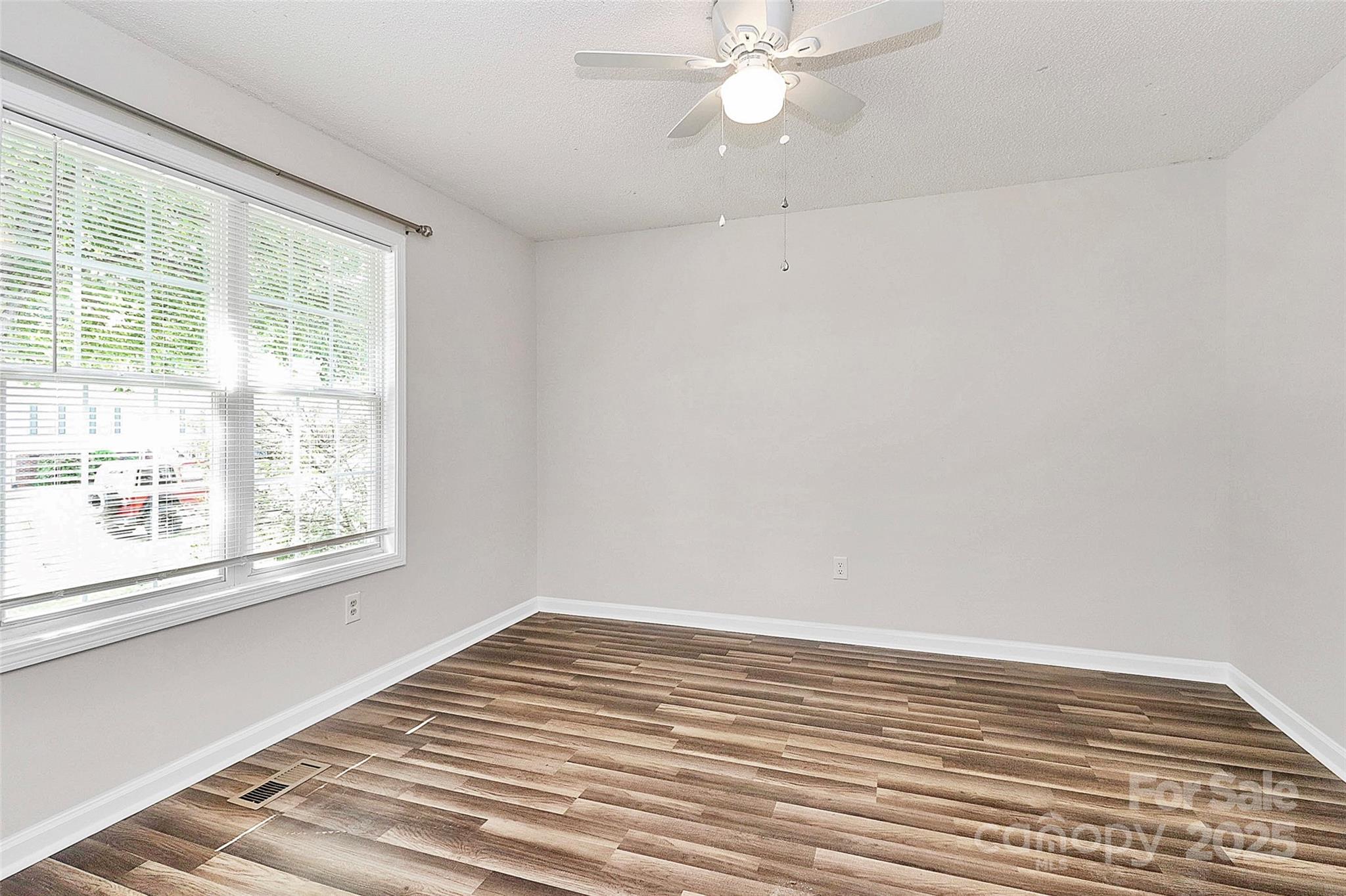 5114 Daffodil Lane Concord, NC 28025 - Photo 21 of 30 a view of a room with wooden floor and fan in a room
