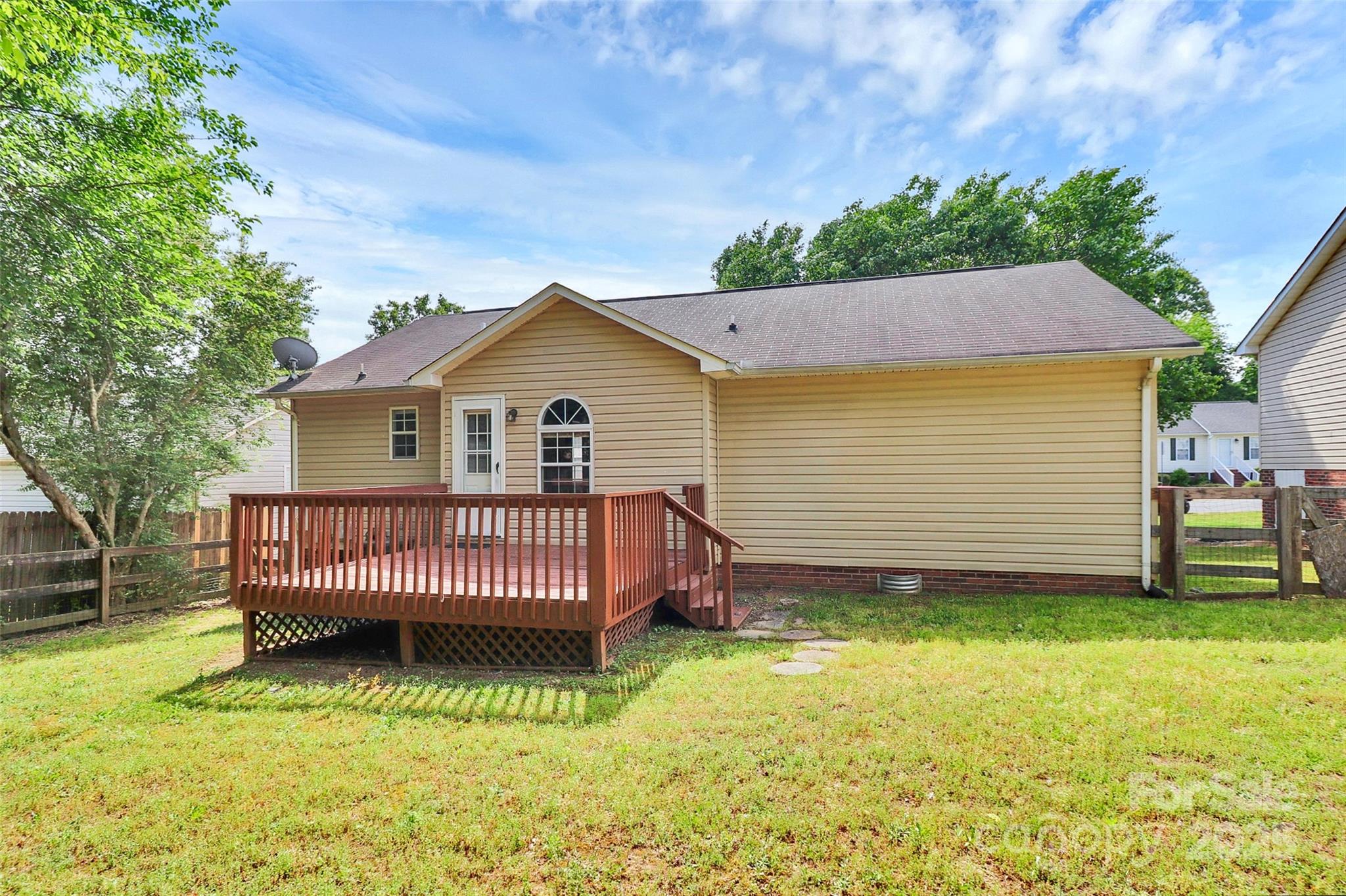 5114 Daffodil Lane Concord, NC 28025 - Photo 23 of 30 a view of a house with a yard and deck