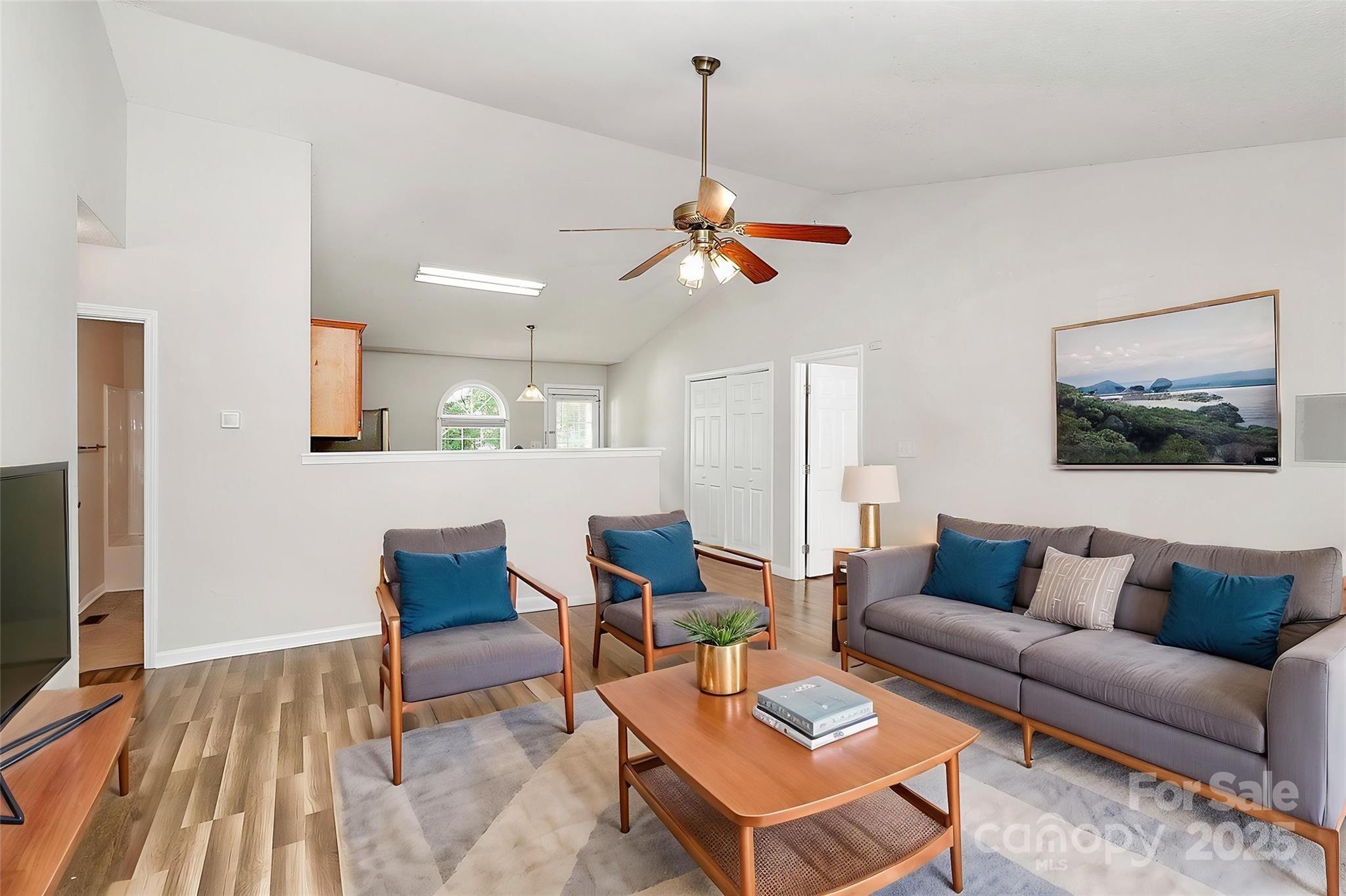 5114 Daffodil Lane Concord, NC 28025 - Photo 4 of 30 a living room with furniture a rug and a flat screen tv