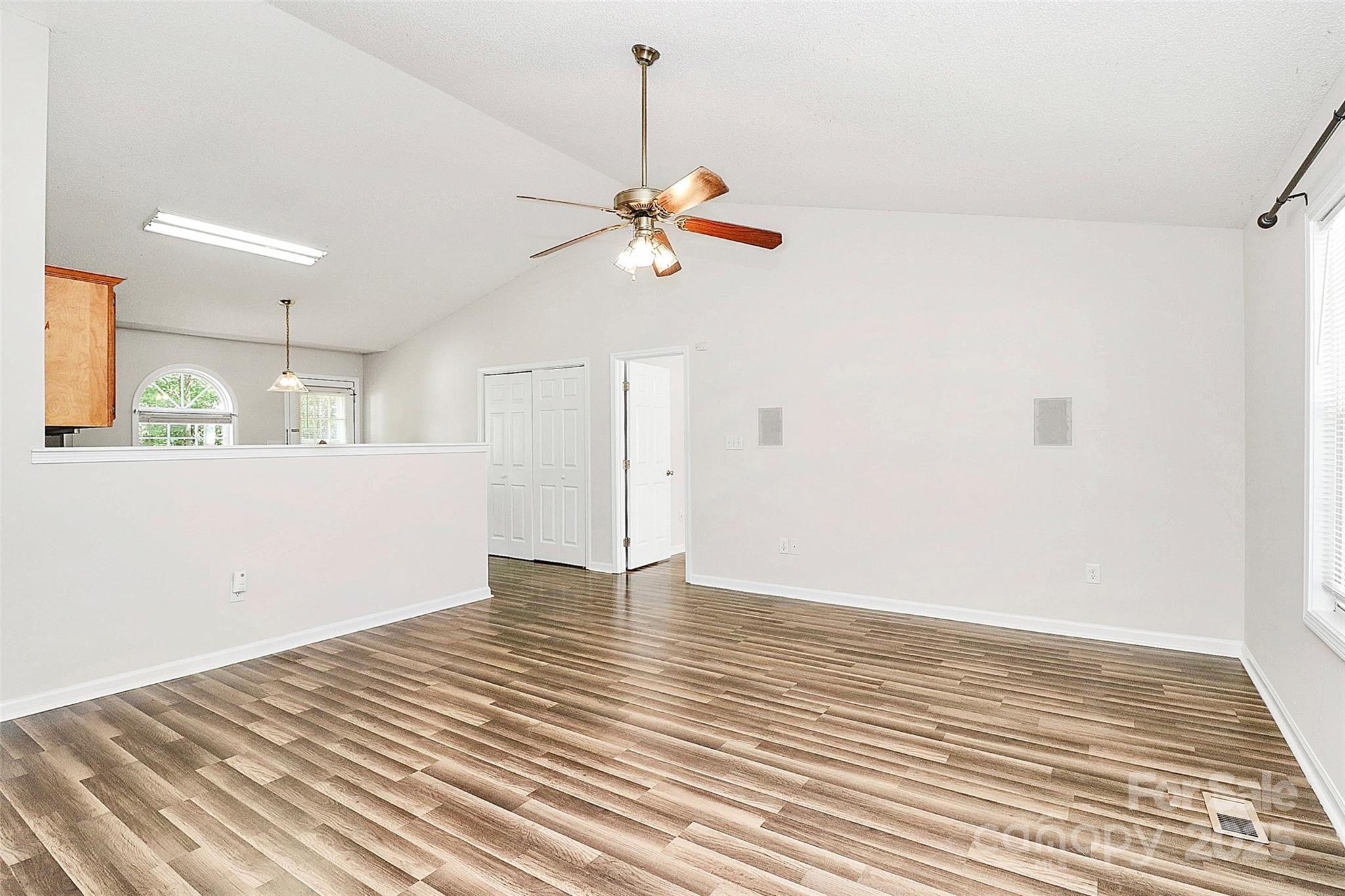 5114 Daffodil Lane Concord, NC 28025 - Photo 5 of 30 a view of a room with wooden floor and a ceiling fan