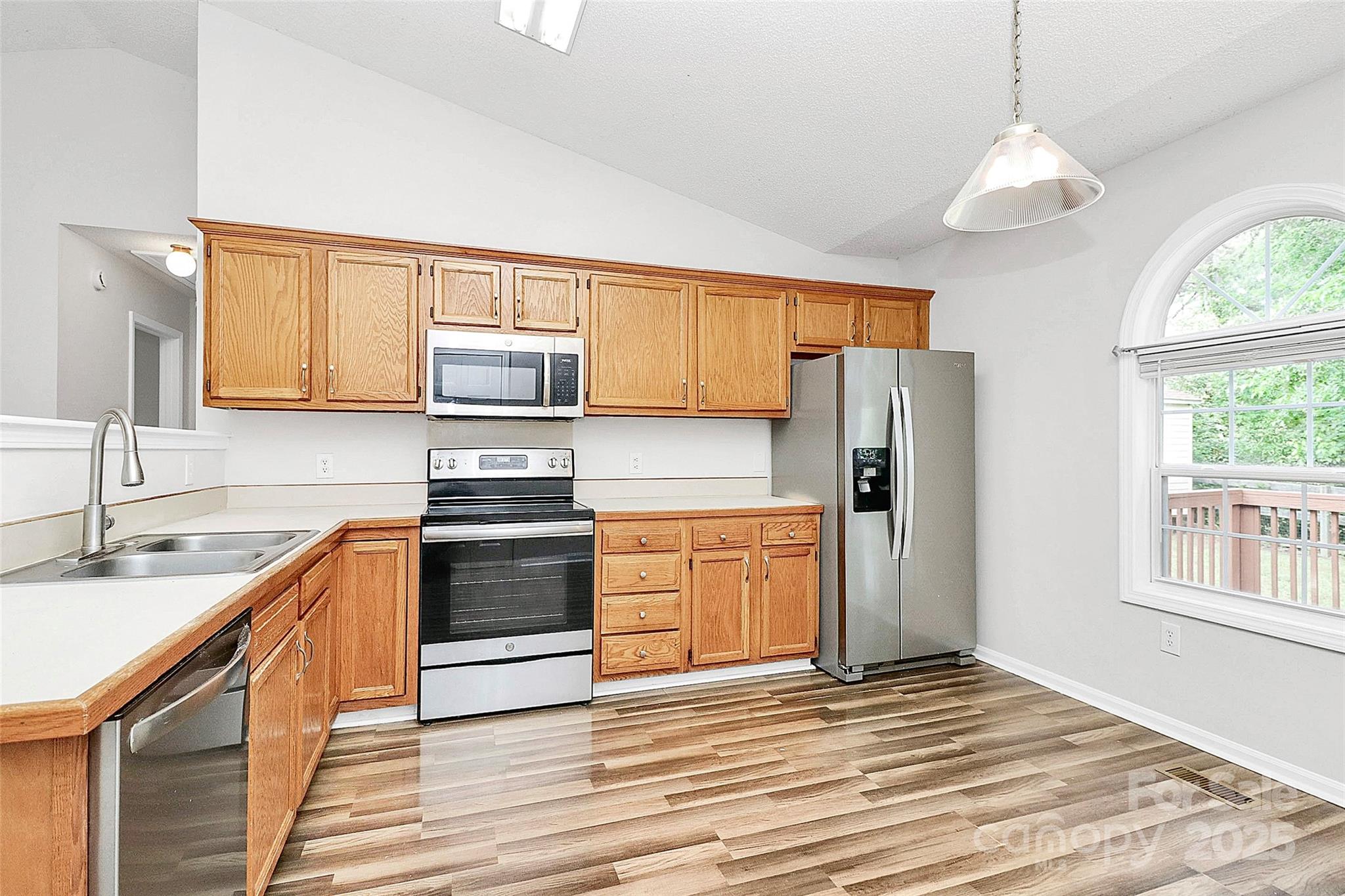 5114 Daffodil Lane Concord, NC 28025 - Photo 8 of 30 a kitchen with stainless steel appliances granite countertop a refrigerator and a stove top oven