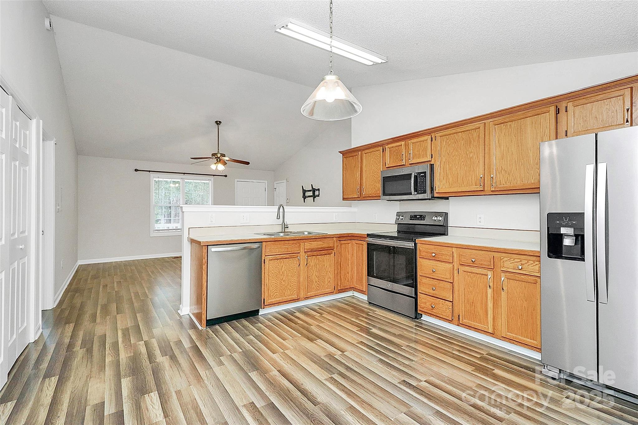 5114 Daffodil Lane Concord, NC 28025 - Photo 9 of 30 a kitchen with a sink window and stainless steel appliances