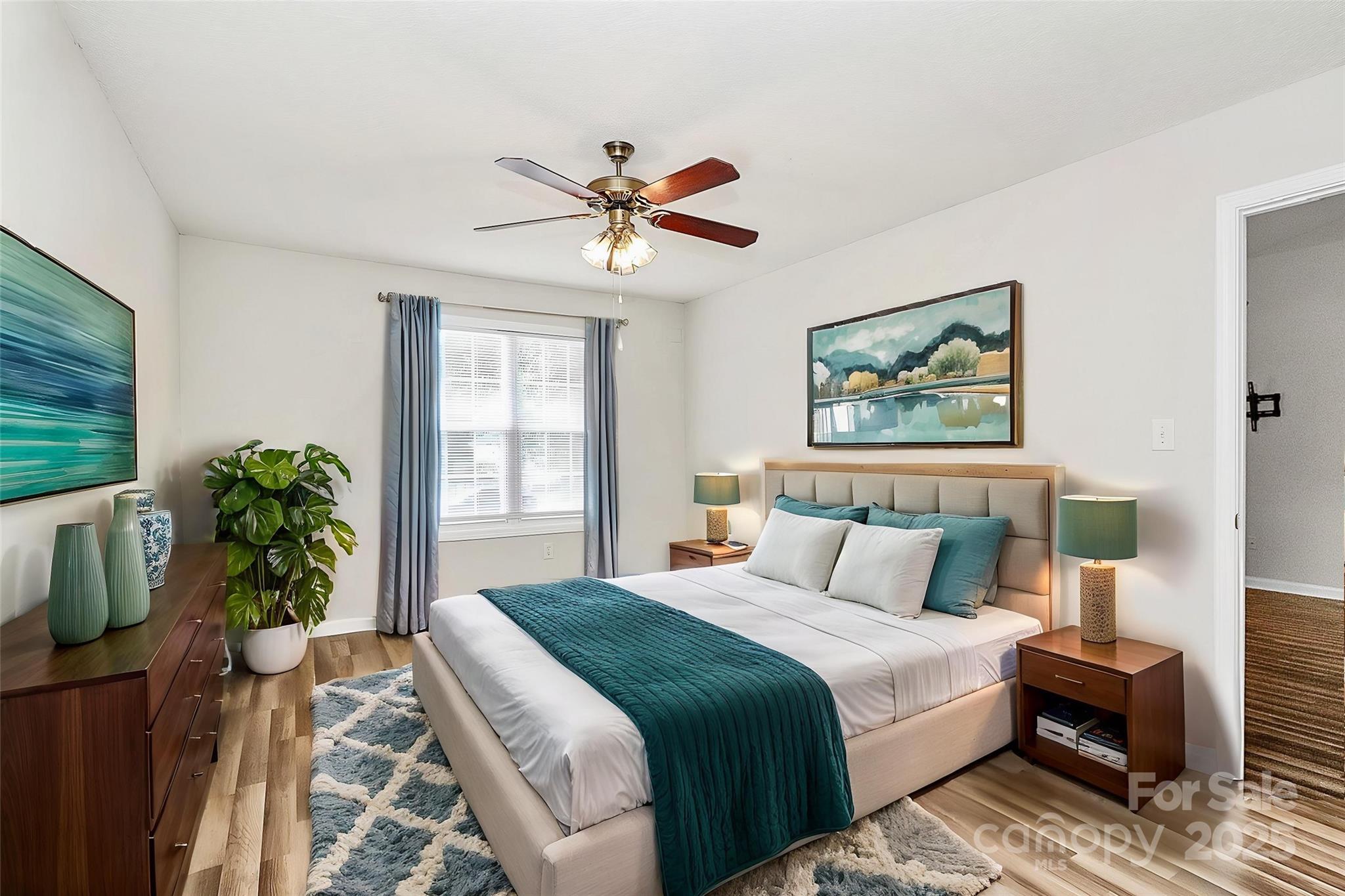 5114 Daffodil Lane Concord, NC 28025 - Photo 10 of 30 a bedroom with a large bed and a chandelier