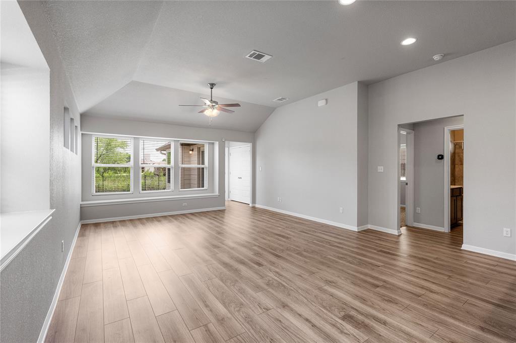 4719 Portillo Way Pflugerville, TX 78660 - Photo 22 of 27 Gleaming wood floors anchor a spacious living area underneath an elegant vaulted ceiling.