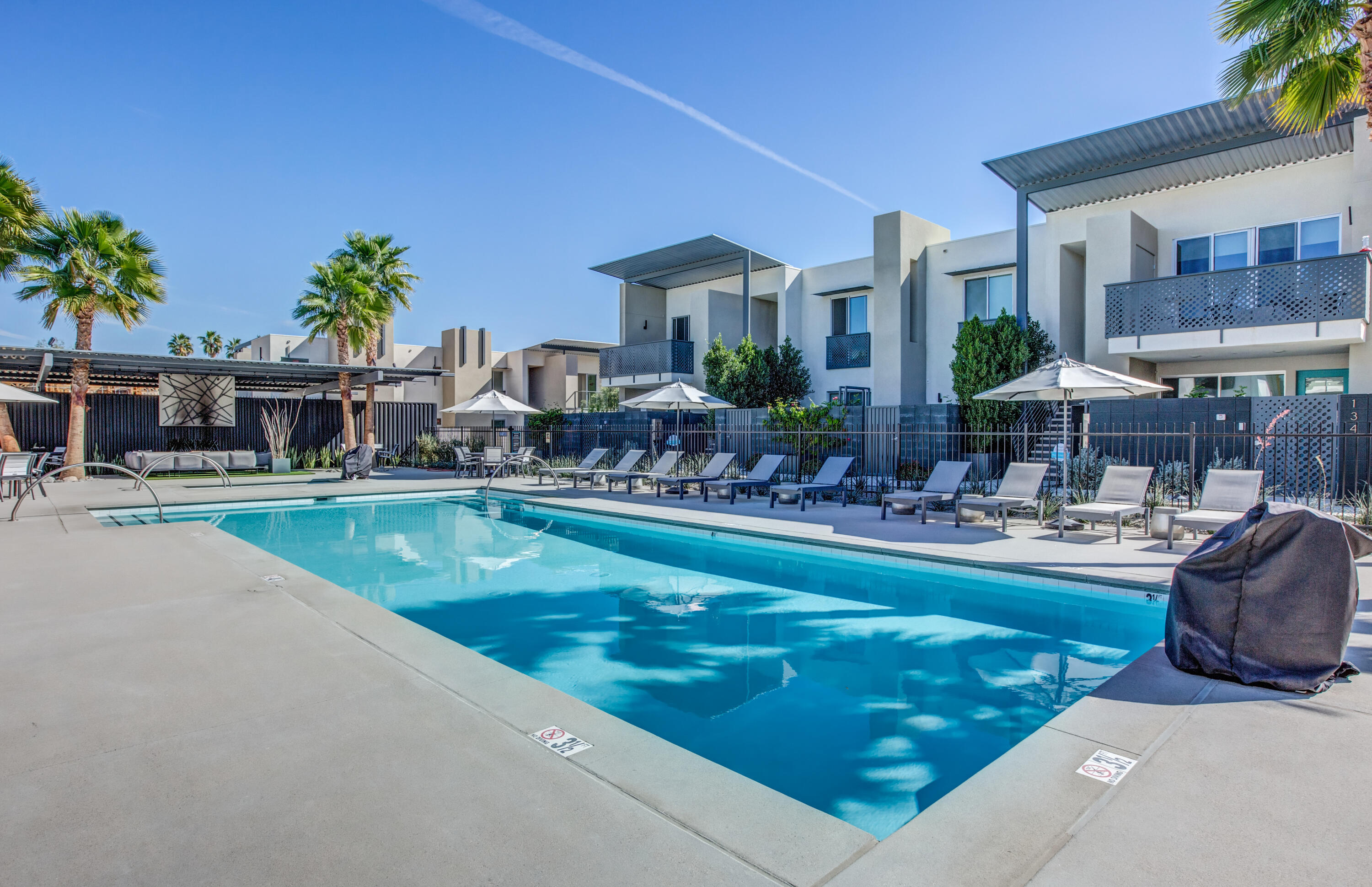 205 The River Palm Springs, CA 92262 - Photo 37 of 43 a view of swimming pool with outdoor seating and a patio