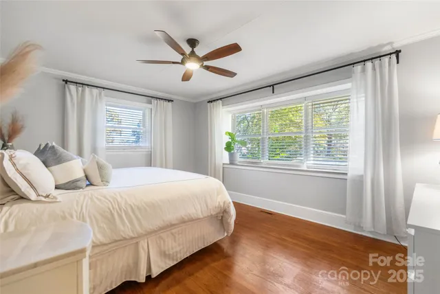 a bedroom with a large bed and a large window