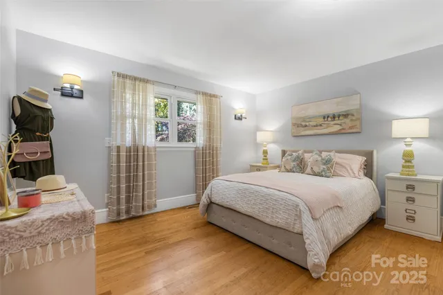 a bedroom with a bed and a flat tv screen on the dresser