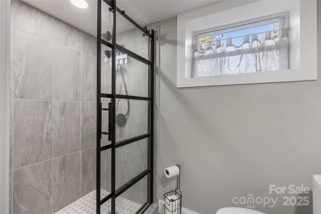 a bathroom with a glass shower door