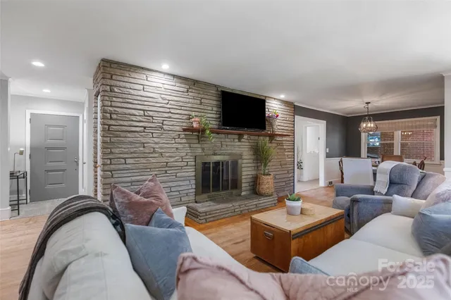 a living room with furniture flat screen tv and a fireplace