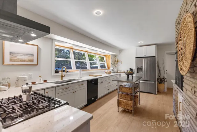a kitchen with a sink stove and cabinets