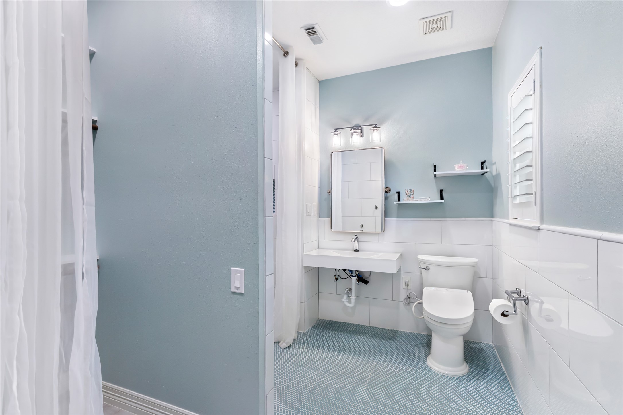 17302 Pipestone Point Court Humble, TX 77346 - Photo 36 of 50 En suite bathroom has a floating sink and open shelving