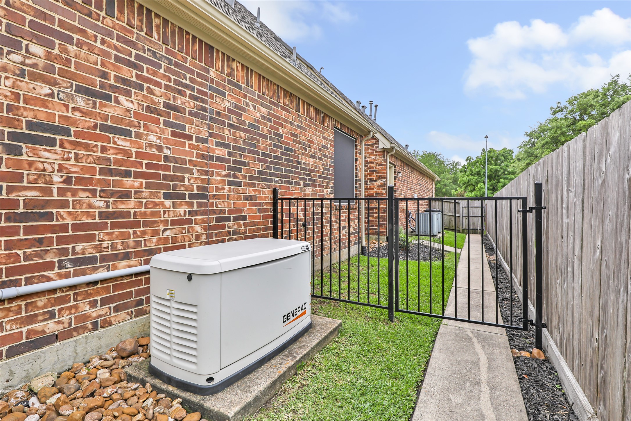 17302 Pipestone Point Court Humble, TX 77346 - Photo 43 of 50 Generac generator puts your mind at ease located beside a fenced, dog-run area