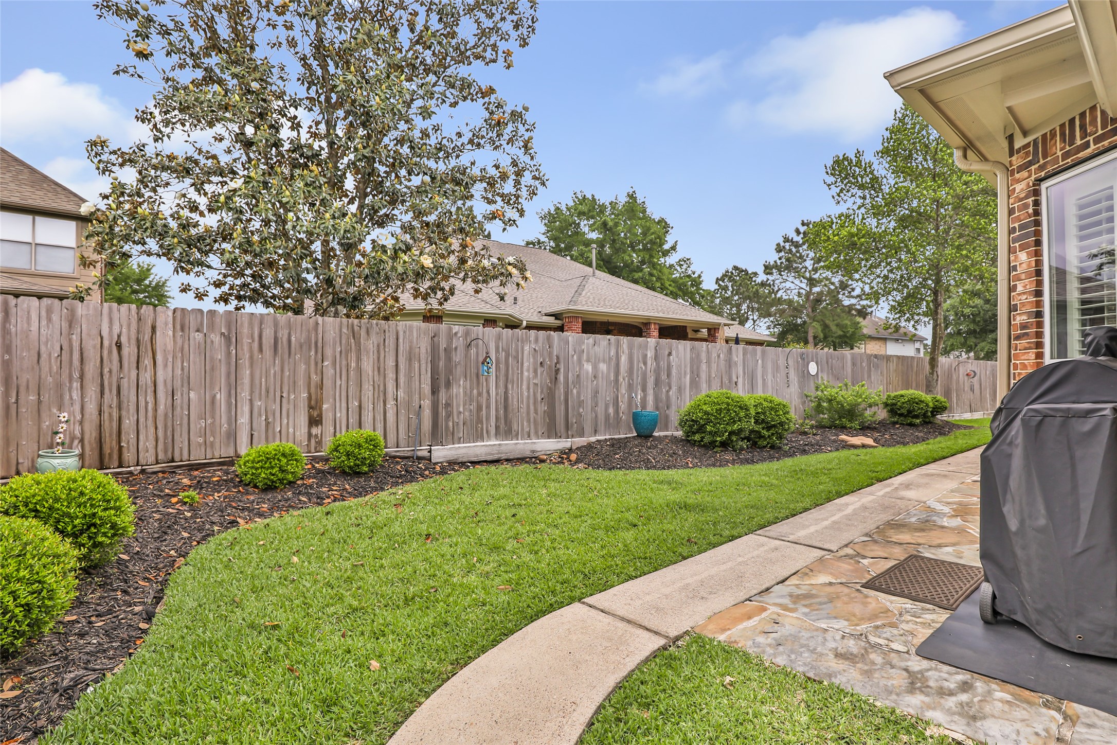 17302 Pipestone Point Court Humble, TX 77346 - Photo 46 of 50 Backyard has maintained landscaping and stone pathways for ease of movement