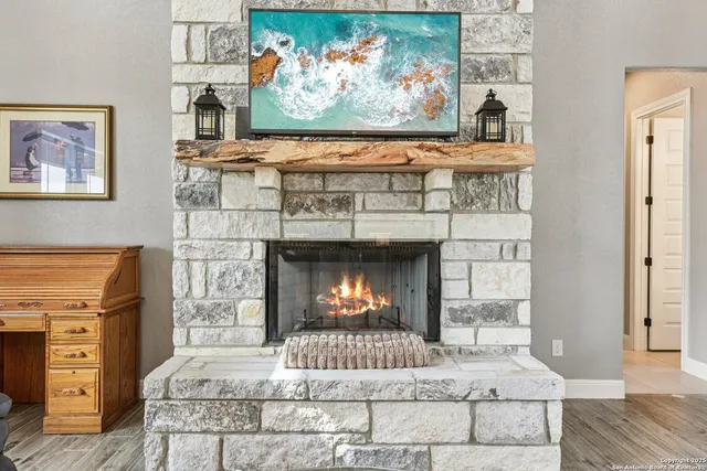 a kitchen with stainless steel appliances a dining table chairs and wooden floor