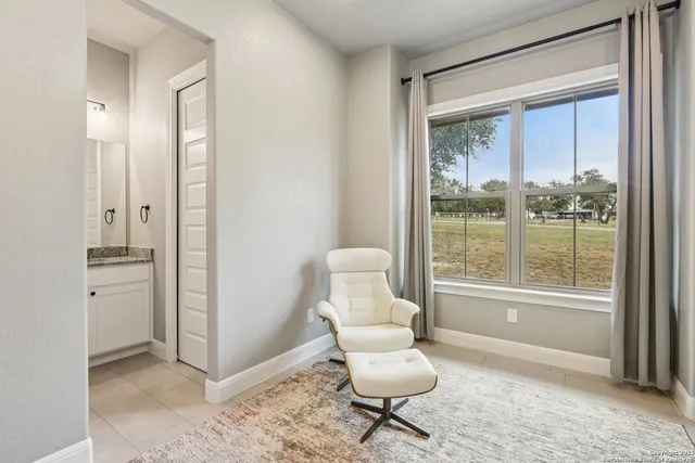 a bedroom with a bed and a lamp on the dresser