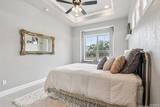 a bedroom with a large bed and a chandelier