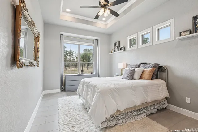 a bedroom with a bed window and table