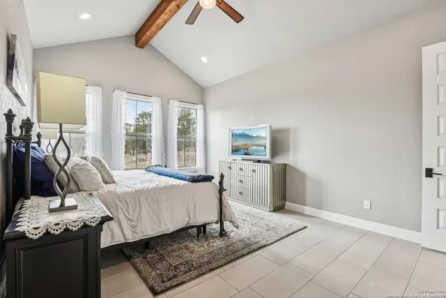 a bedroom with a bed and a painting on the wall