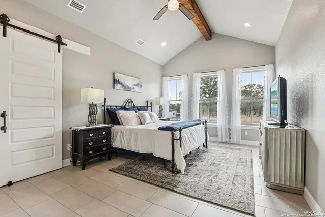 a bedroom with furniture and a flat screen tv