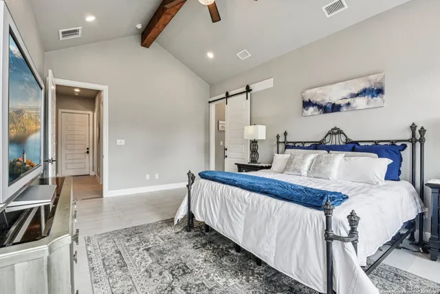 a bathroom with a granite countertop sink two mirror and shower