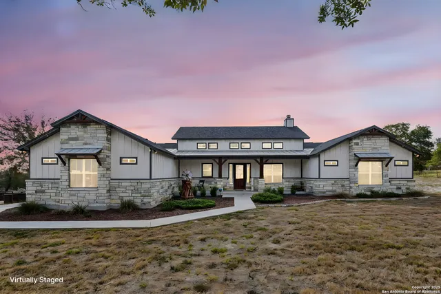 a living room with furniture kitchen view and a wooden floor